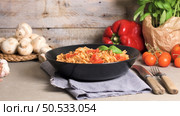 Italian Pasta with Tuna and Basil. Fresh pasta with tuna and tomato sauce on old wooden background. Стоковое фото, агентство Ingram Publishing / Фотобанк Лори