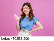 Portrait of happy young woman wearing casual t-shirt waving hands isolated over pink background. Expression, people and lifestyle concept. Стоковое фото, агентство Ingram Publishing / Фотобанк Лори