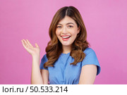 Portrait of happy young woman wearing casual t-shirt waving hands isolated over pink background. Expression, people and lifestyle concept. Стоковое фото, агентство Ingram Publishing / Фотобанк Лори
