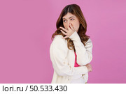 Portrait of Disgusted young woman holding nose to avoid smelling a foul and unpleasant stench against isolated over pink background. Emotion and lifestyle concept. Стоковое фото, агентство Ingram Publishing / Фотобанк Лори