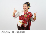 Portrait young pretty woman dress up in beautiful  local culture in northern region with gladtful posture, smile and thumb up on white background, copy space. Стоковое фото, агентство Ingram Publishing / Фотобанк Лори