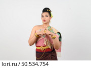 Portrait Young beautiful woman in northeastern dress, she raising fingers in a cross to reject with feel upset on white background, copy space . Стоковое фото, агентство Ingram Publishing / Фотобанк Лори