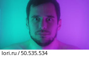Man Opening Eyes Submerged in Luminous Neon Water. Стоковое видео, видеограф Илья Шаматура / Фотобанк Лори