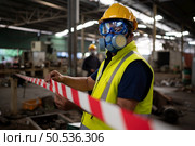 Restricted area, officials employ white and red stripes to block the area where a chemical leak is occurring. To prevent individuals from coming into contact with potentially dangerous chemicals, Стоковое фото, агентство Ingram Publishing / Фотобанк Лори