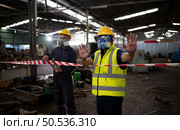 Restricted area, officials employ white and red stripes to block the area where a chemical leak is occurring. To prevent individuals from coming into contact with potentially dangerous chemicals, Стоковое фото, агентство Ingram Publishing / Фотобанк Лори