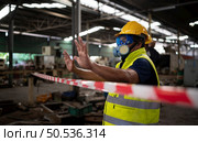 Restricted area, officials employ white and red stripes to block the area where a chemical leak is occurring. To prevent individuals from coming into contact with potentially dangerous chemicals, Стоковое фото, агентство Ingram Publishing / Фотобанк Лори