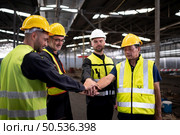 Engineers and technicians must join forces when they want to accomplish big tasks. Uniting together to help each other make great things happen. Стоковое фото, агентство Ingram Publishing / Фотобанк Лори