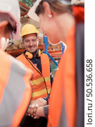 The manager encouraged the warehouse workers to work hard to get the goods out of the warehouse to finish the small merchants tonight. By joining hands and creating a boom. Стоковое фото, агентство Ingram Publishing / Фотобанк Лори