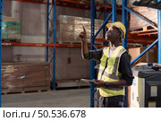Portrait of warehouse workers in a large warehouse with their own preparation for the day’s work. Стоковое фото, агентство Ingram Publishing / Фотобанк Лори