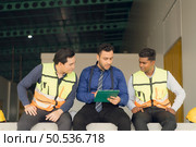 A warehouse manager and two employees are resting after dealing with how to organize the shelves in a large warehouse. Стоковое фото, агентство Ingram Publishing / Фотобанк Лори