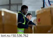 Group of worker in auto parts warehouse Packing small parts in boxes after inspecting the car parts that are ready to be sent to the car assembly plant. Стоковое фото, агентство Ingram Publishing / Фотобанк Лори