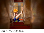 Head of worker portrait  in an auto parts warehouse, Examine auto parts that are ready to be shipped to the automobile assembly factory. Стоковое фото, агентство Ingram Publishing / Фотобанк Лори