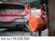 The car crashed so hard that the car body collapsed into distortion. A car body puller is required to restore the car body to its original shape. Стоковое фото, агентство Ingram Publishing / Фотобанк Лори