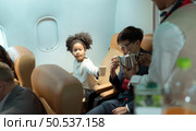 Flight attendant serving beverages to business class passengers. Стоковое фото, агентство Ingram Publishing / Фотобанк Лори