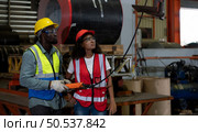 Two technicians Inspecting and testing the operation of lifting cranes in heavy industrial plants. Стоковое фото, агентство Ingram Publishing / Фотобанк Лори