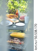 Chef cooking by grilling to wait for camping activity. Стоковое фото, агентство Ingram Publishing / Фотобанк Лори