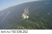 Aerial kite view of kitesurfer gliding across river on a windy day. Стоковое фото, агентство Ingram Publishing / Фотобанк Лори