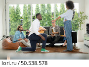 A group of multiethnic friends having fun at a party and witness their friend’s marriage proposal. Стоковое фото, агентство Ingram Publishing / Фотобанк Лори