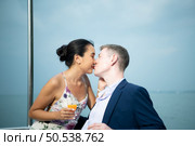 Happy moments of interracial couples on a yacht The couple had their honeymoon at one of Asia’s most beautiful seas. Стоковое фото, агентство Ingram Publishing / Фотобанк Лори