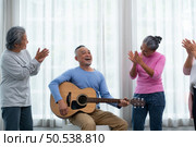 Old people’s companions To unwind during the weekend, gather together for activities like singing, playing the guitar, and chit-chatting. Стоковое фото, агентство Ingram Publishing / Фотобанк Лори