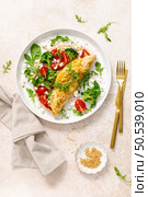 Omelette stuffed with tomato, broccoli feta cheese and fresh green salad. Healthy diet food for breakfast. Top view. Стоковое фото, агентство Ingram Publishing / Фотобанк Лори