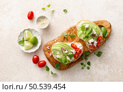 Avocado toast with cheese cottage, tomato and herbs for breakfast. Стоковое фото, агентство Ingram Publishing / Фотобанк Лори