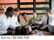 Group of diverse business people working together in the office, Brainstorming about the hand robot model to be used for production work. Стоковое фото, агентство Ingram Publishing / Фотобанк Лори