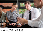 Group of diverse business people working together in the office, Brainstorming about the hand robot model to be used for production work. Стоковое фото, агентство Ingram Publishing / Фотобанк Лори