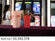 Both of young woman stand and watch the movie program to watch today. Стоковое фото, агентство Ingram Publishing / Фотобанк Лори