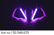 Bare-Chested Man Drawing Two Glowing Neon Tubes from His Back. Стоковое видео, видеограф Илья Шаматура / Фотобанк Лори