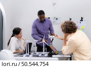 Group of multi-national team of architects and designers is meeting to brainstorm designs for wind turbines to capture wind energy and convert it into electrical energy. Стоковое фото, агентство Ingram Publishing / Фотобанк Лори