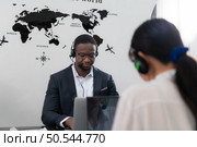 Portrait of business people wearing headset working actively in office. Call center, telemarketing, customer support agent provide service on telephone video conference call. Стоковое фото, агентство Ingram Publishing / Фотобанк Лори