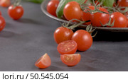 Small red cherry tomatoes on rustic background. Cherry tomatoes on the vine. Стоковое фото, агентство Ingram Publishing / Фотобанк Лори