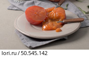 Persimmon fruit on rustic table in vintage style. Стоковое фото, агентство Ingram Publishing / Фотобанк Лори