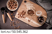 Vegan chocolate spread made of organic almond butter and organic cacao and honey, on dark rustic kitchen counter top. Стоковое фото, агентство Ingram Publishing / Фотобанк Лори