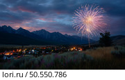 Spectacular fireworks illuminate the night sky over a mountain town during a summer celebration. Стоковое AI-изображение, AI-художник Сергей Толмачёв / Фотобанк Лори