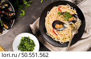 Homemade pasta spaghetti with mussels , peppers and parsley on rustic background. sea food meal. Стоковое фото, агентство Ingram Publishing / Фотобанк Лори