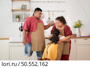 A plus-size family with a father wearing a prosthetic leg, Eat together after cooking and daughter drinks milk for health in the dining room of the house. Стоковое фото, агентство Ingram Publishing / Фотобанк Лори