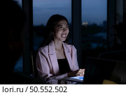 Both of young Asian broker international stock traders working together on desktop at night office, International financial investment company concept. Стоковое фото, агентство Ingram Publishing / Фотобанк Лори