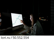 Both of young Asian broker international stock traders working together on desktop at night office, International financial investment company concept. Стоковое фото, агентство Ingram Publishing / Фотобанк Лори