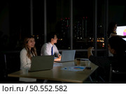 Group of broker international stock traders working actively at night in office, Everyone is striving for the team’s success. Стоковое фото, агентство Ingram Publishing / Фотобанк Лори