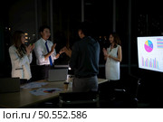 Group of broker international stock traders working actively at night in office, Everyone is congratulating the team on their success. Стоковое фото, агентство Ingram Publishing / Фотобанк Лори