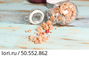 Glass jar with healthy breakfast cereal on wooden table. Стоковое фото, агентство Ingram Publishing / Фотобанк Лори