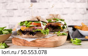 Healthy vegan burger with fresh vegetables and yogurt sauce on rustic kitchen counter top. Стоковое фото, агентство Ingram Publishing / Фотобанк Лори