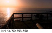 Sunset view from the wooden walkway on Carrapateira, District Aljezur, Algarve Portugal. Стоковое фото, агентство Ingram Publishing / Фотобанк Лори