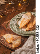 A crescent-shaped pastry whose filling is made of eggs and almonds wrapped in crispy dough, cut in an artisanal way and sprinkled with sugar. Стоковое фото, агентство Ingram Publishing / Фотобанк Лори