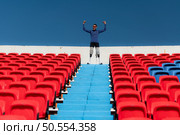 Athletes with disabilities cheer from the stands in a sports arena. Стоковое фото, агентство Ingram Publishing / Фотобанк Лори