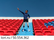 Athletes with disabilities cheer from the stands in a sports arena. Стоковое фото, агентство Ingram Publishing / Фотобанк Лори