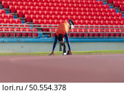 Disabled athletes prepare in starting position ready to run on stadium track. Стоковое фото, агентство Ingram Publishing / Фотобанк Лори