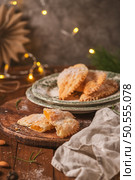 A crescent-shaped pastry whose filling is made of eggs and almonds wrapped in crispy dough, cut in an artisanal way and sprinkled with sugar. Стоковое фото, агентство Ingram Publishing / Фотобанк Лори